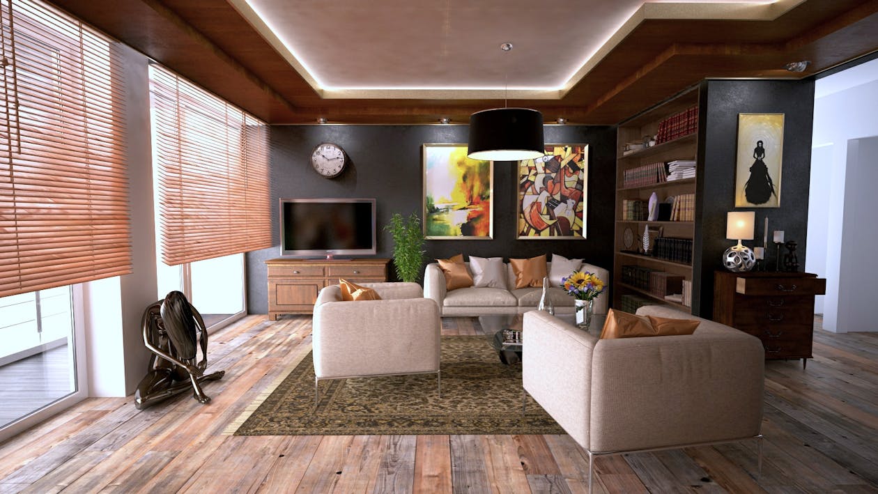 A couple sits together on a sofa in a bright, modern living room, collaboratively reviewing a Tennessee listing agreement before signing.