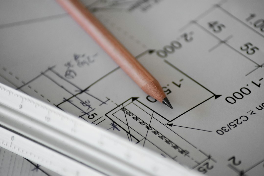 An architect's hands sketching a detailed technical blueprint on a bright, modern desk, symbolizing the strategic design of an SEO system.