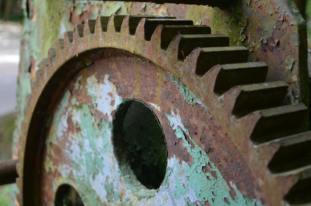 A close-up of clean, intricate metal gears interlocking and moving smoothly, representing an efficient, engineered framework without friction.