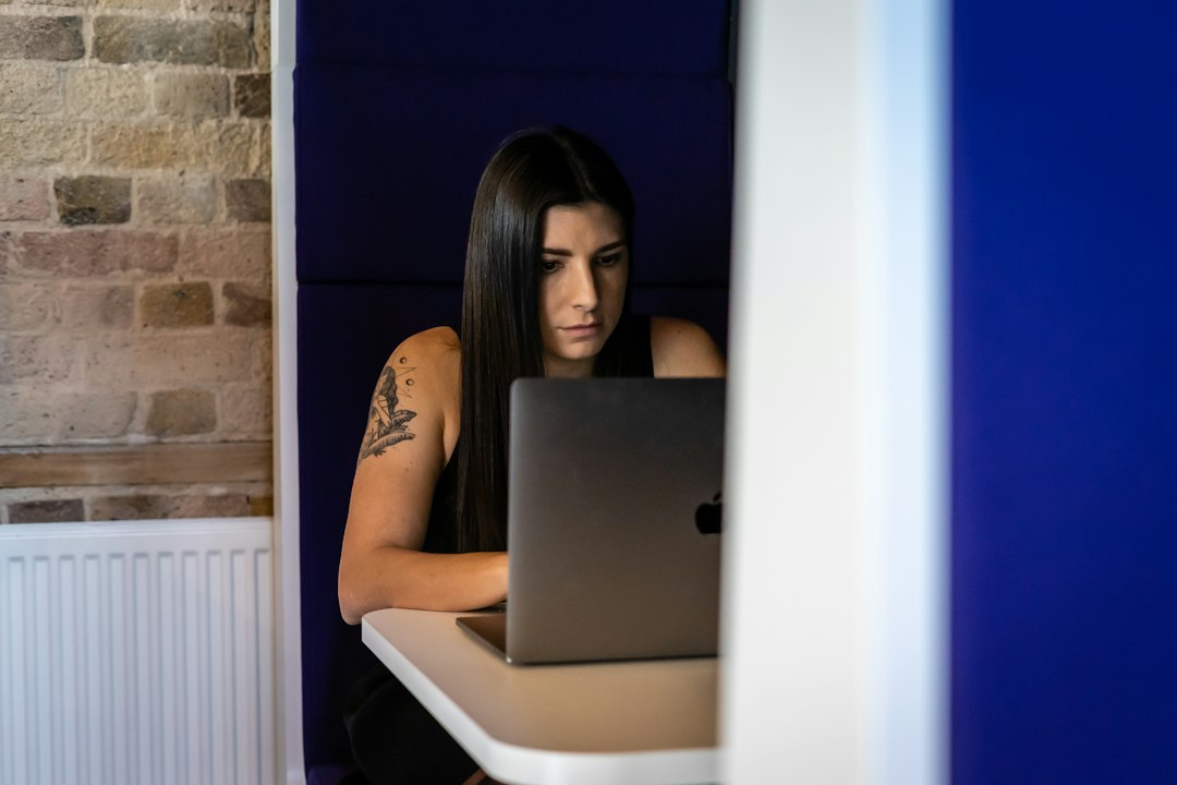 A man or woman in a modern setting looking at a laptop screen with a confused and skeptical expression, representing doubt in search engine results.